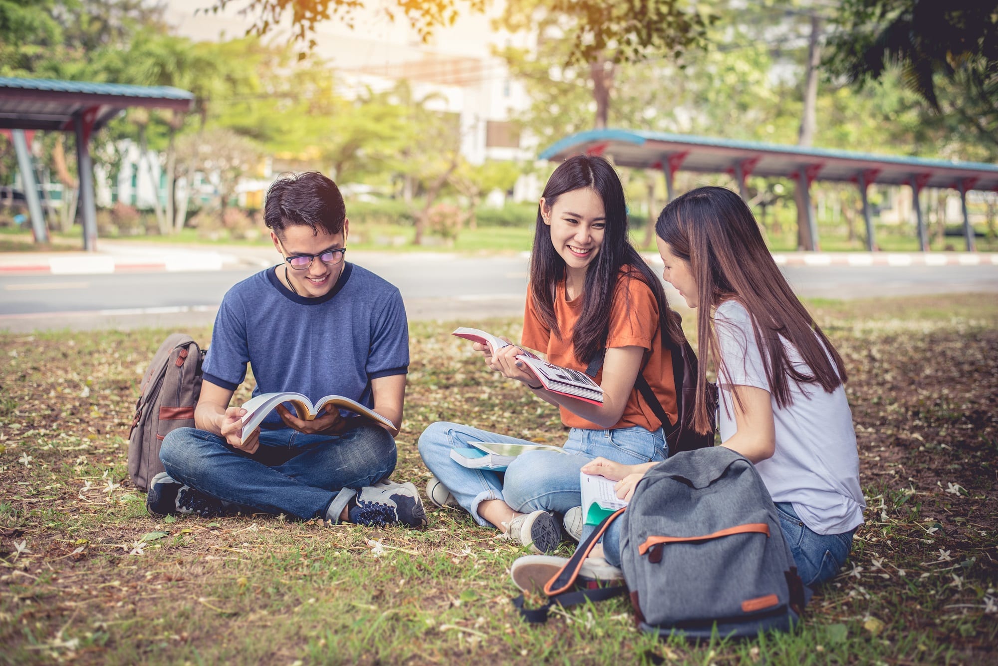 Group Of Asian College Student Reading Books And Tutoring Specia