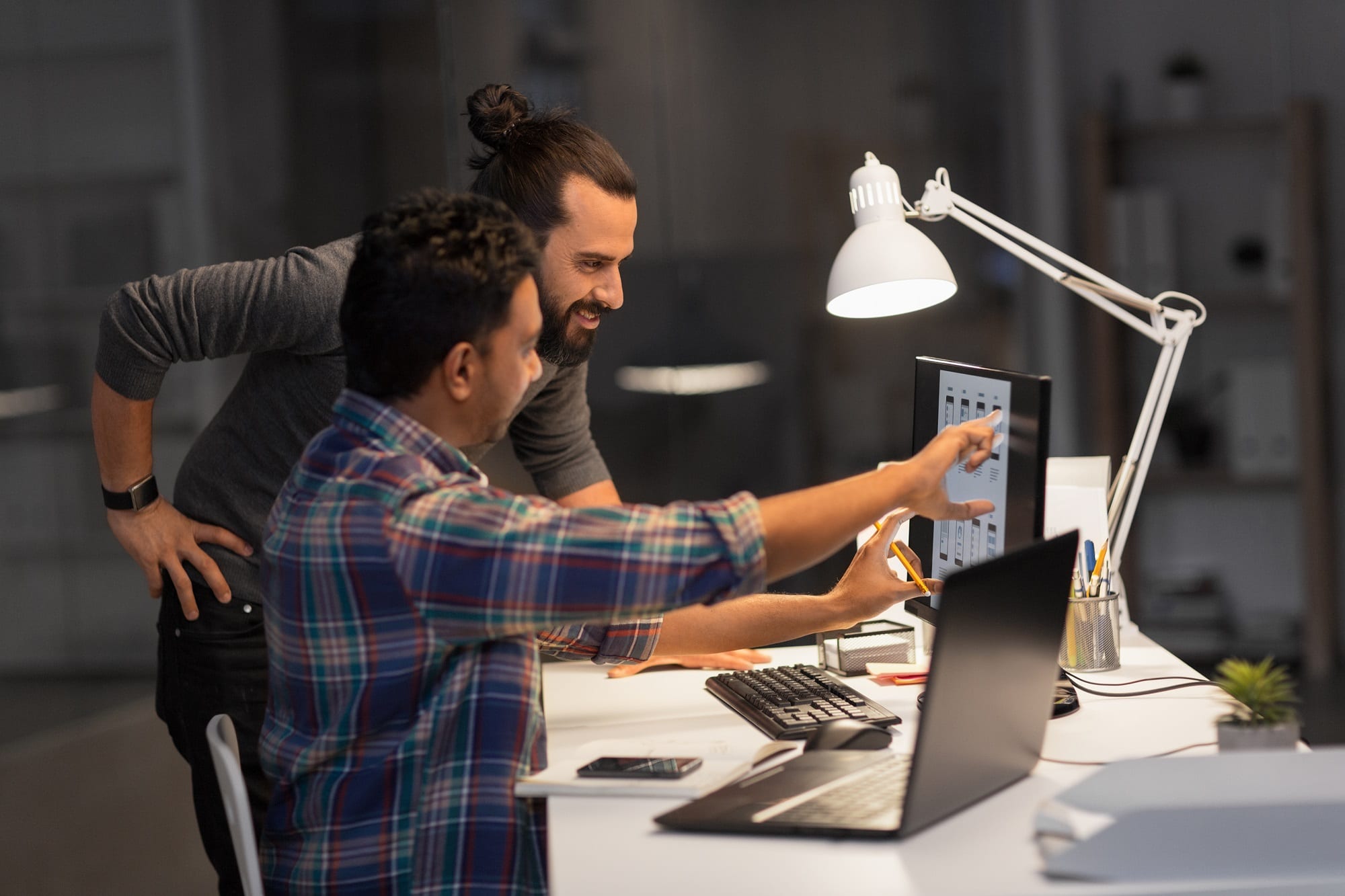 Creative Team With Computer Working Late At Office