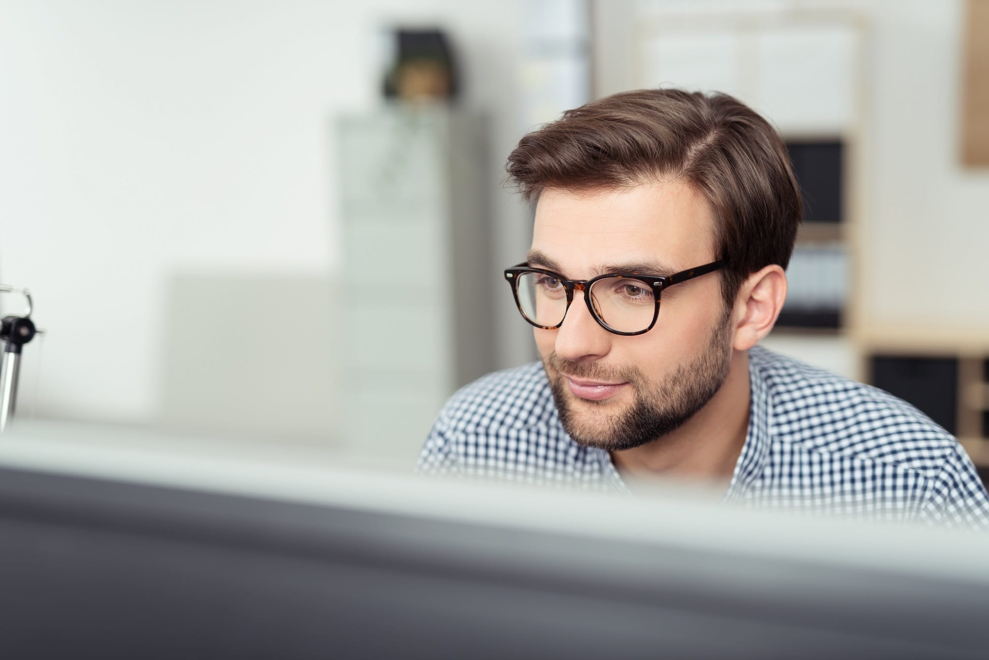 Businessman At His Desk Facing The Computer Screen