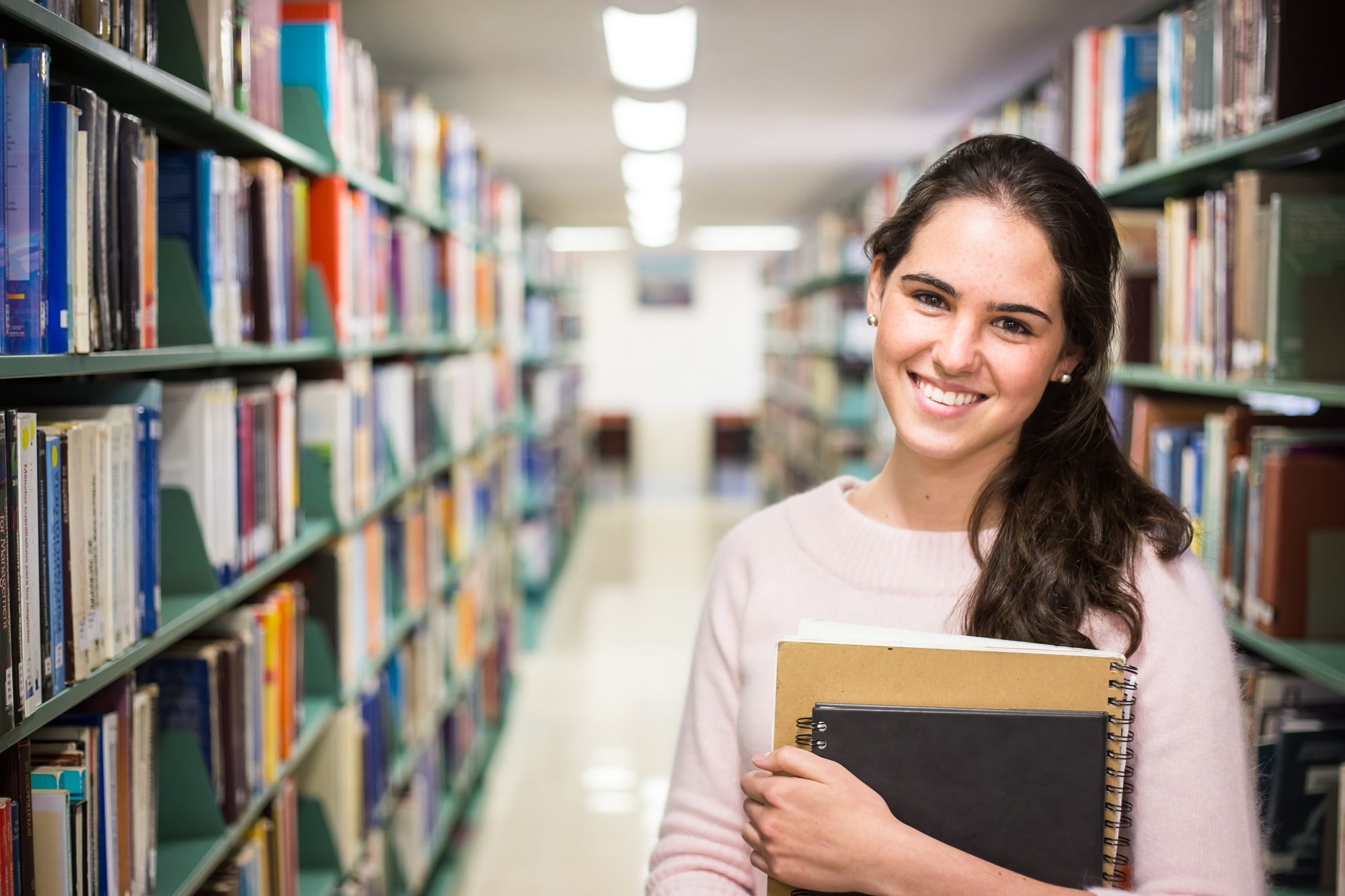 In The Library Pretty Female Student With Books Working In A H