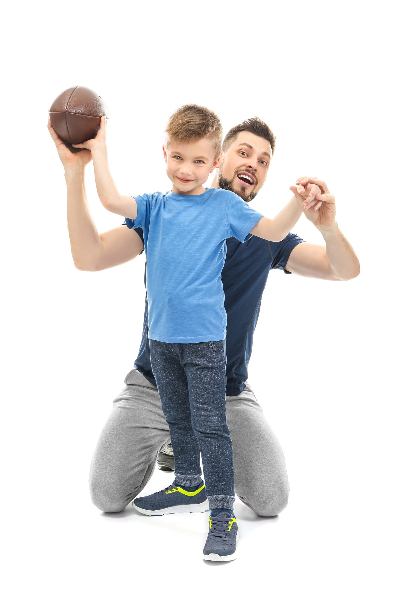 Handsome Man And His Son With Rugby Ball On White Background