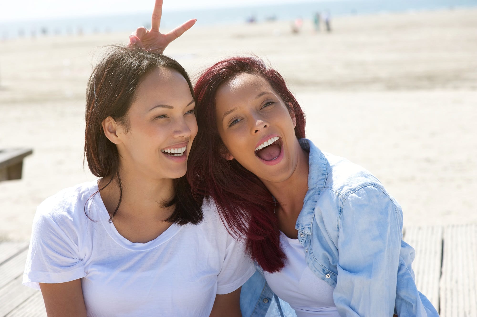 Cheerful Sisters Having Fun At The Beach