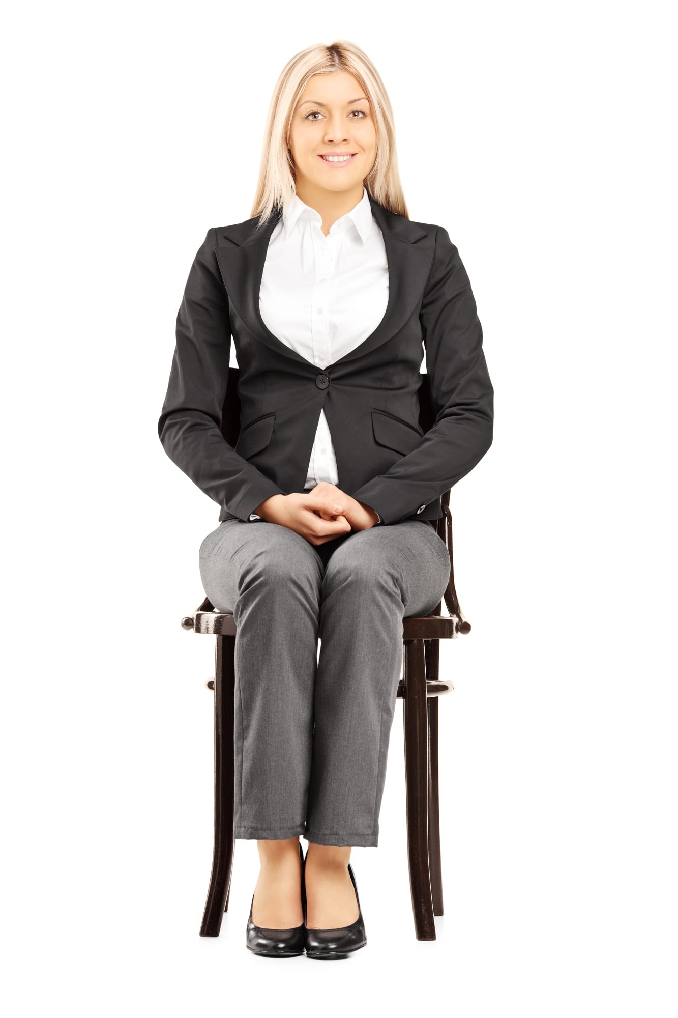 Confident Blond Businesswoman In Suit Sitting On A Chair