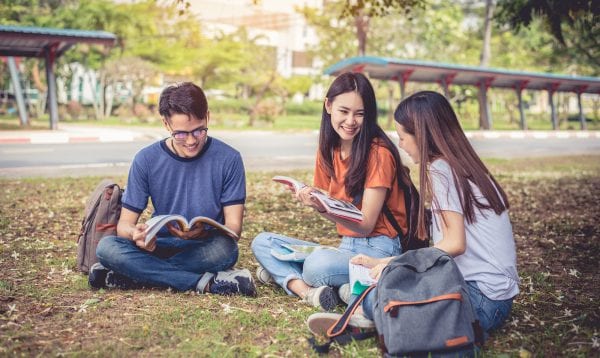 Group Of Asian College Student Reading Books And Tutoring Specia