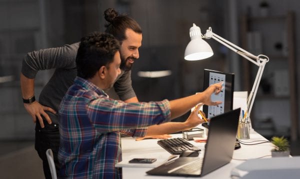 Creative Team With Computer Working Late At Office