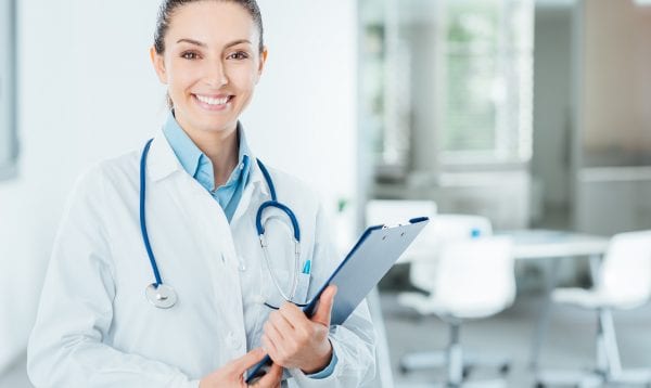 Smiling Female Doctor Holding Medical Records